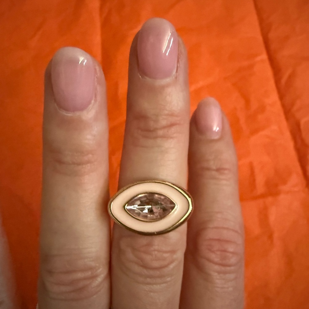 Gold Tome and White Eye-Shaped Ring